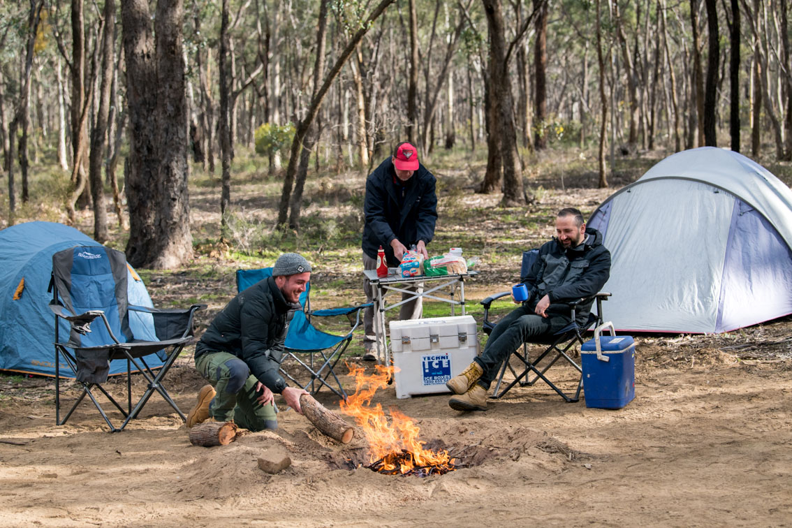 People camping and building a campfire